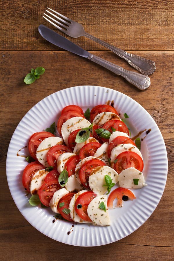 Italian Caprese Salad with Sliced Tomatoes, Mozzarella Cheese, Basil