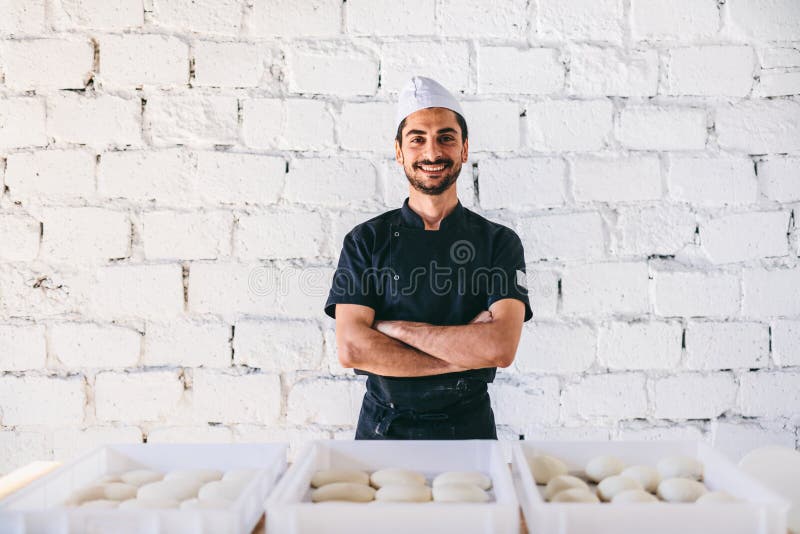 Italian Chef Pizzaiolo with Dough for Pizza in Restaurant Kitchen Stock