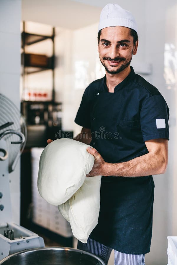 Italian Chef Pizzaiolo Preparing Pizza Dough in Restaurant Kitchen
