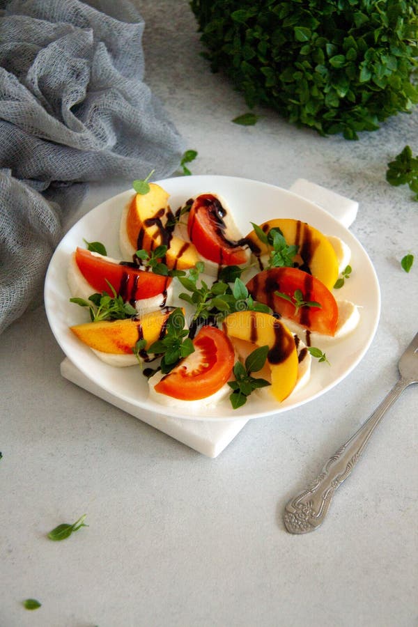 Italian salad with mozzarella, tomato, peach and basil