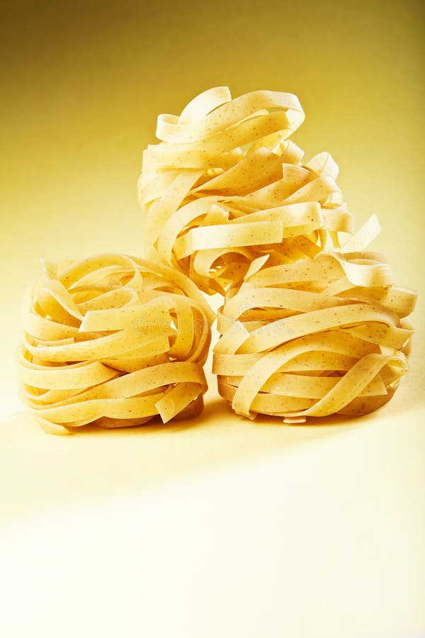 Italian pasta fettuccine on yellow gradient