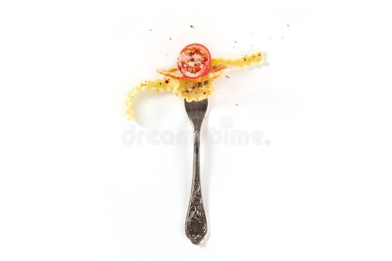 Italian pasta. A vintage fork with fusilli, chicken meat, and a cherry tomato