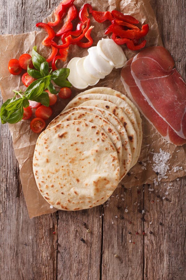 Italian Piadina Flatbread, Ham, Cheese and Vegetables Closeup. Stock