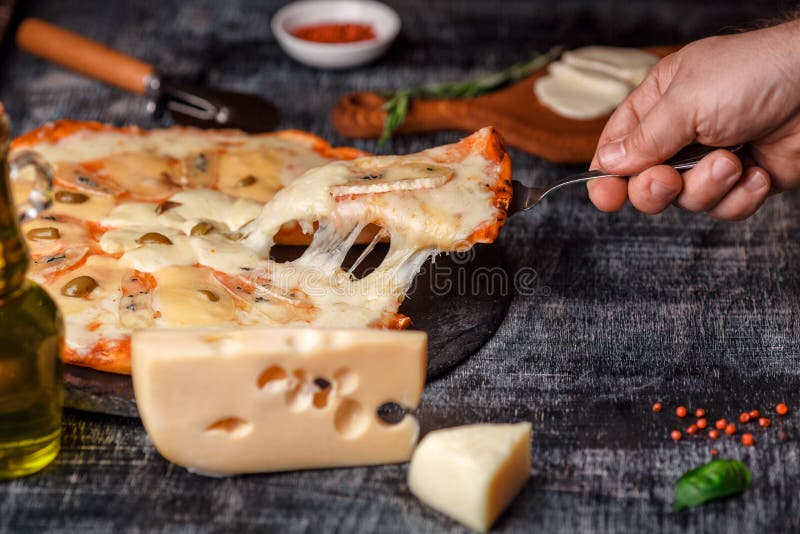 Italian pizza with different sorts of cheese on a stone and a black scratched chalk board. Italian traditional food royalty free stock photos Italian pizza with different sorts of cheese on a stone and a black scratched chalk board. Italian traditional food royalty free stock photos