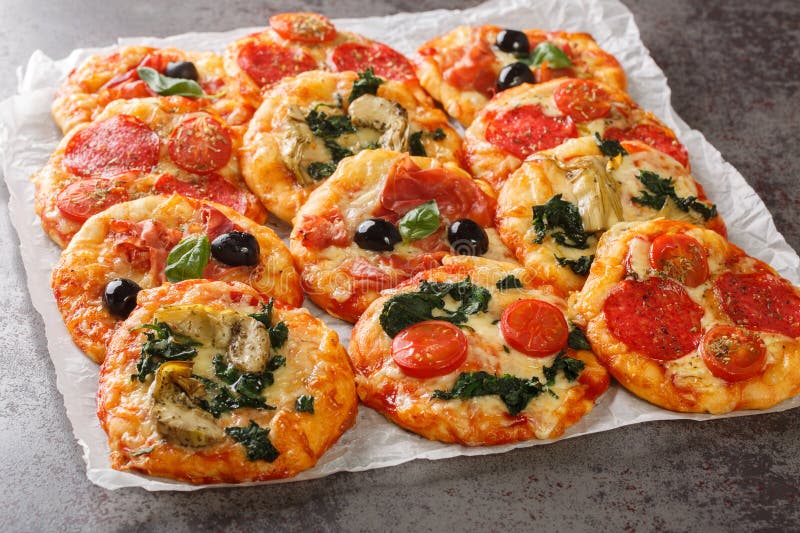 Italian Pizzette Mini Pizza Bites with Assorted Toppings Close-up on ...