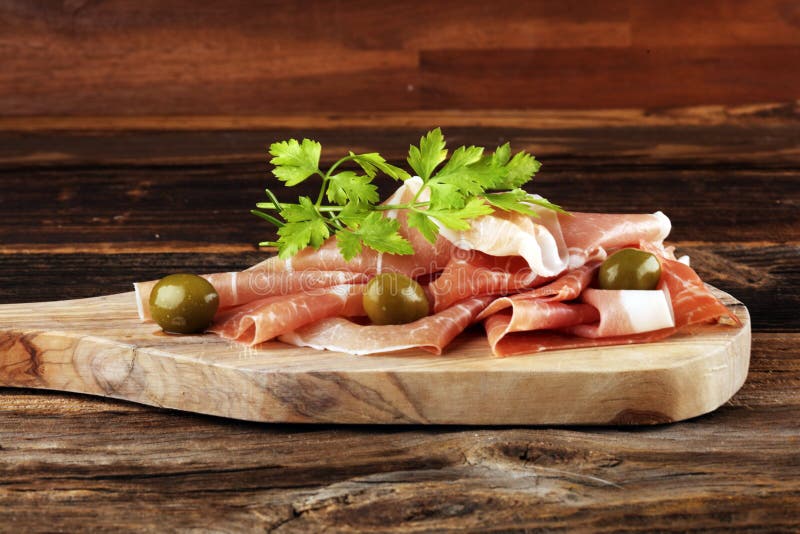 Italian Prosciutto Crudo or Jamon with Rosemary. Raw Ham Appetizer on