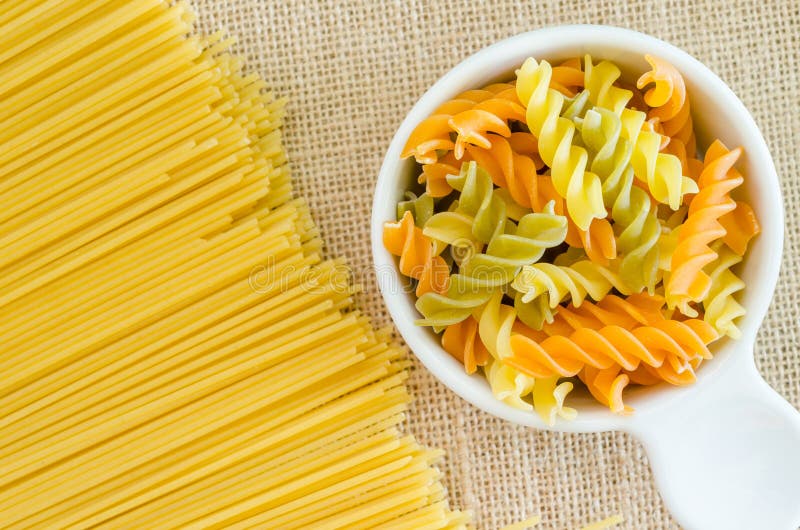 Italian raw pasta with uncooked pasta spaghetti macaroni.