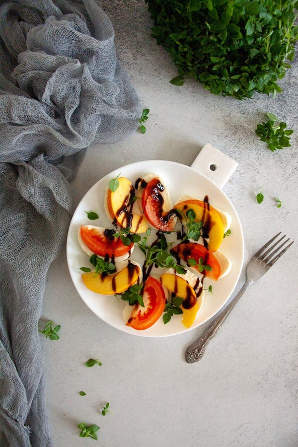 Italian salad with mozzarella, tomato, peach and basil