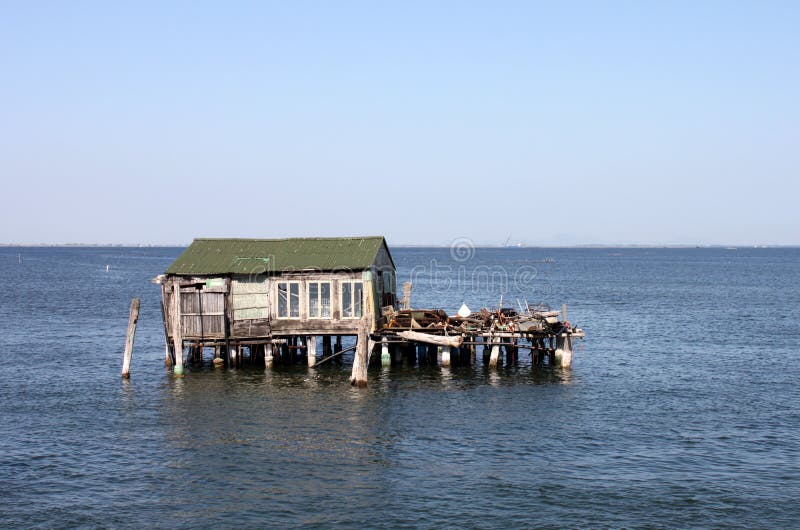 Italy. House of fisher in the water on blue sky background, horizontal view. royalty free stock image Italy. House of fisher in the water on blue sky background, horizontal view. royalty free stock image