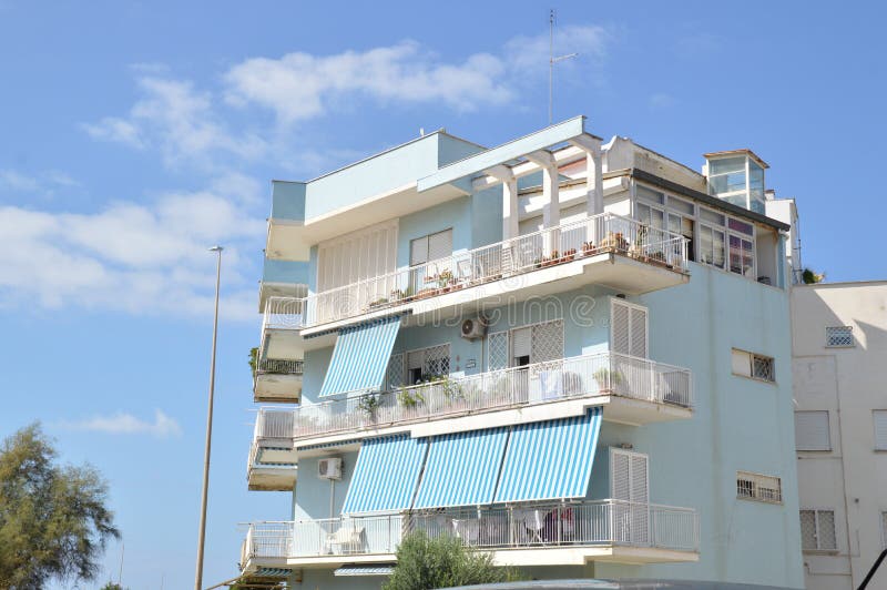 Italy, Rome, Ostia, Tyrrhenian Sea. Typical residential apartments. Blue house with balconies, windows covered royalty free stock photography Italy, Rome, Ostia, Tyrrhenian Sea. Typical residential apartments. Blue house with balconies, windows covered royalty free stock photography