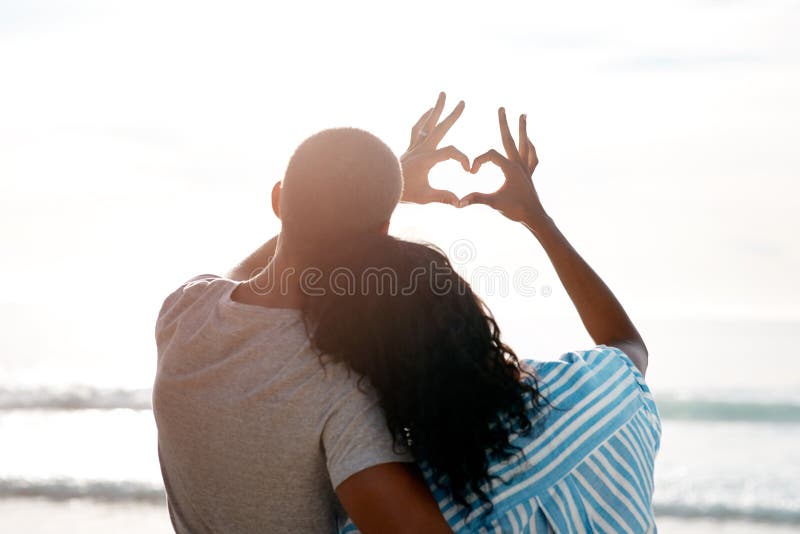 Youve Taught Me The True Meaning Of Love. A Couple Forming A Heart Shape  With Their Hands While Sitting On The Beach. Stock Photo, Picture and  Royalty Free Image. Image 198911221.