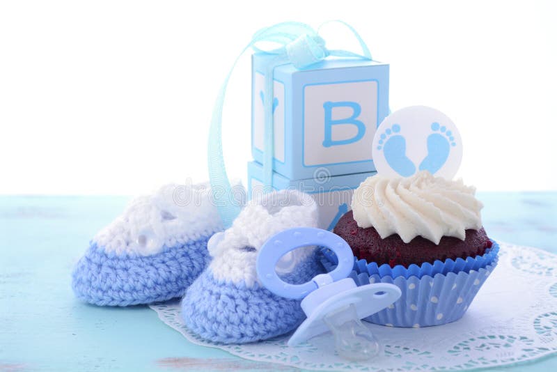 Its a Boy Blue Baby Shower Cupcakes with baby feet toppers and decorations on shabby chic blue wood table.