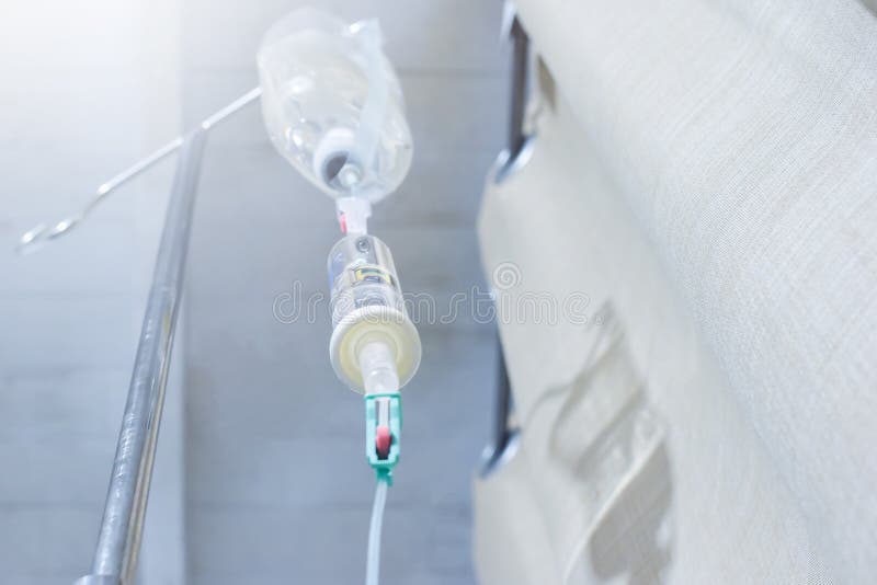 Iv solution infusion, bottom view of saline bottle from the eyes of the patient on bed in the patient room royalty free stock photo Iv solution infusion, bottom view of saline bottle from the eyes of the patient on bed in the patient room royalty free stock photo