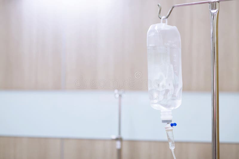 Iv saline bag infusion set and bottle on a pole. fluid intravenous drop saline drip slow hospital room or clinic. medical concept,treatment emergency shock. injection drug infusion care chemotherapy. Iv saline bag infusion set and bottle on a pole. fluid intravenous drop saline drip slow hospital room or clinic. medical concept,treatment emergency shock. injection drug infusion care chemotherapy