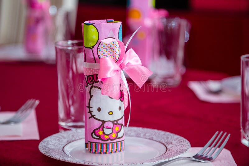 Hello kitty pink paper napkin inside a glass.
