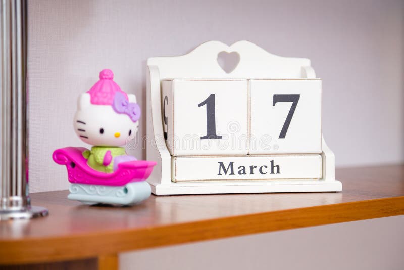 Hello kitty toy and white cubic wooden calendar