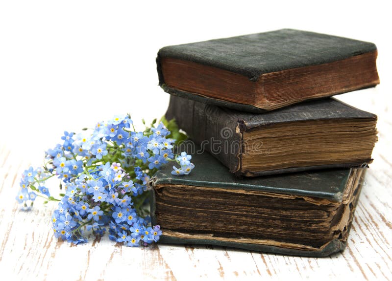 Bunch of forget-me-nots flowers and very old books. Bunch of forget-me-nots flowers and very old books