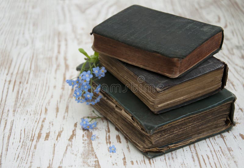 Bunch of forget-me-nots flowers and very old books. Bunch of forget-me-nots flowers and very old books