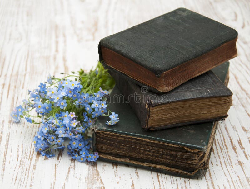 Bunch of forget-me-nots flowers and very old books. Bunch of forget-me-nots flowers and very old books