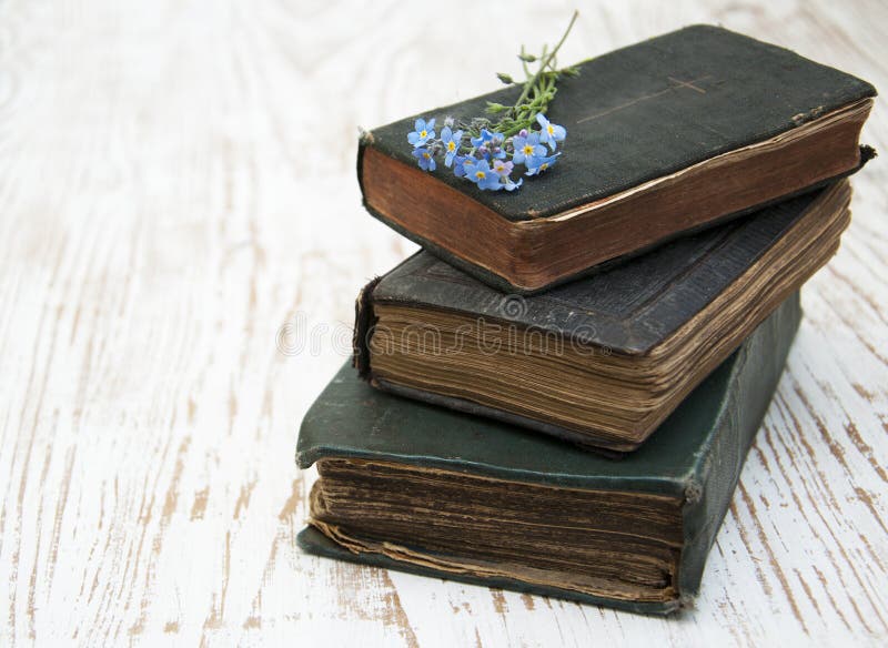 Bunch of forget-me-nots flowers and very old books. Bunch of forget-me-nots flowers and very old books