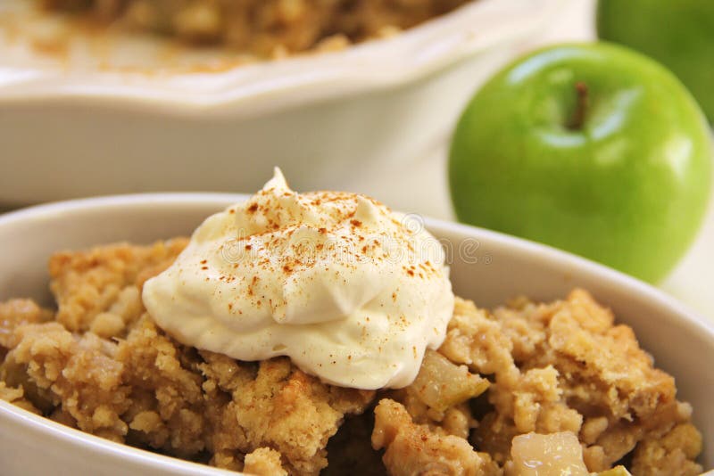 A yummy apple crisp upclose whipped cream cinnamon. A yummy apple crisp upclose whipped cream cinnamon