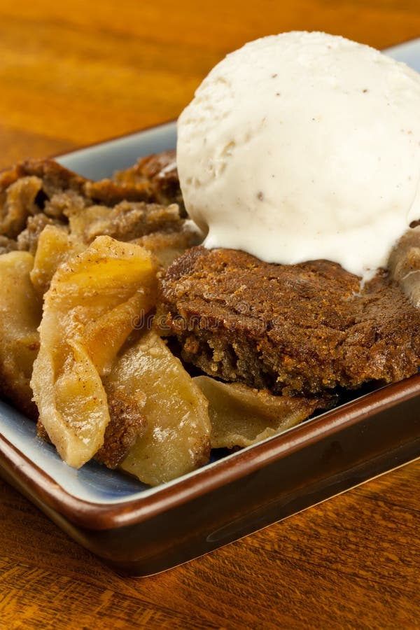 A plate of gluten free, organic apple cobbler with a scoop of ice cream. A plate of gluten free, organic apple cobbler with a scoop of ice cream