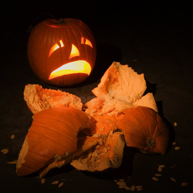 Jack-o -lantern with smashed pumpkin.