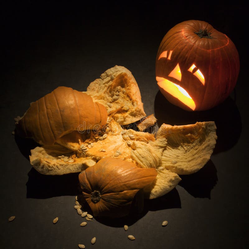 Jack-o -lantern with smashed pumpkin.