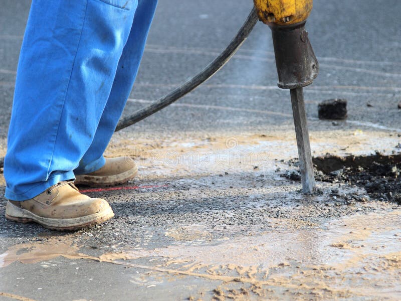 Jackhammer in the construction site on the road