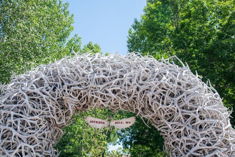 JACKSON HOLE, WY - JULY 12, 2019: Famous Antler Arch at Jackson Town Square, with Cowboy Bar