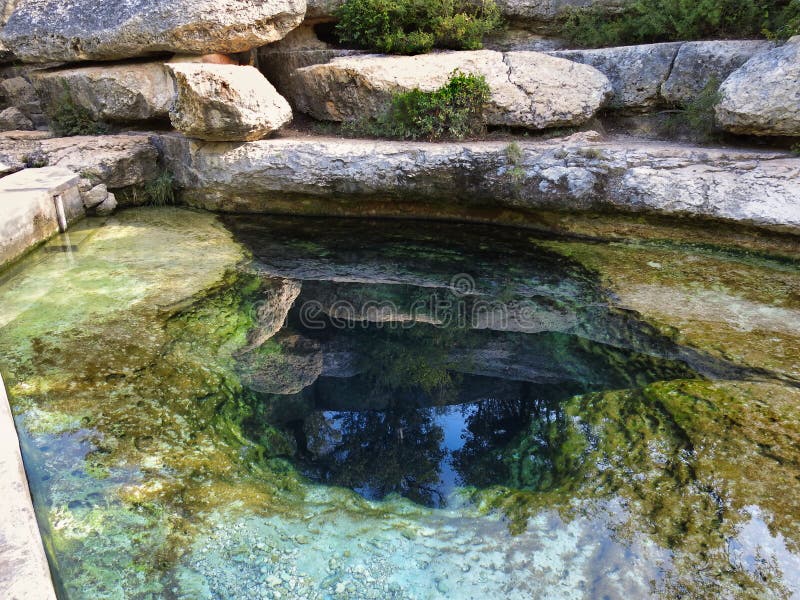 Jacob`s Well is a 140 foot deep artesian spring that releases thousands of gallons of crystal clear water a day. It is the second largest fully submerged cave in Texas. Wimberly, Texas.