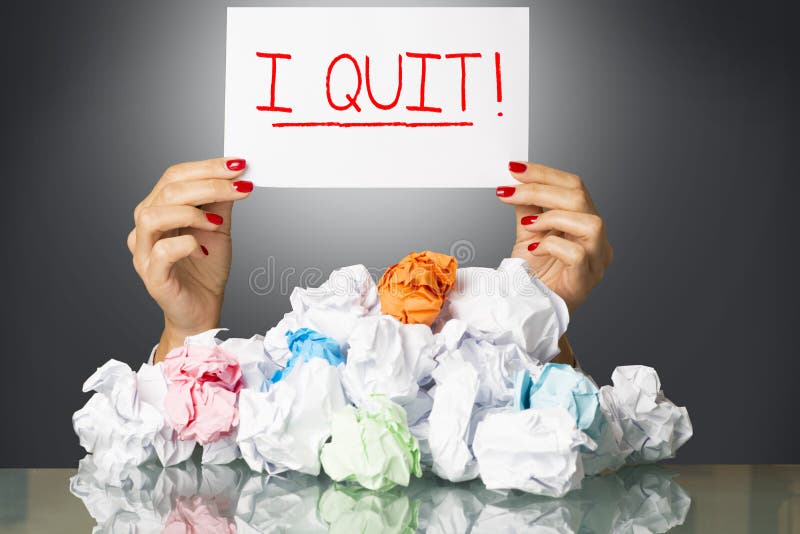 I quit, decision of exhausted employee on white paper, behind  a stack of wastepaper. I quit, decision of exhausted employee on white paper, behind  a stack of wastepaper