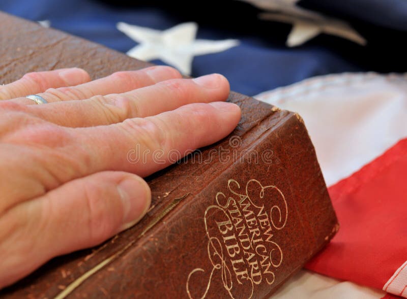 Hand on bible with flag background. Hand on bible with flag background.