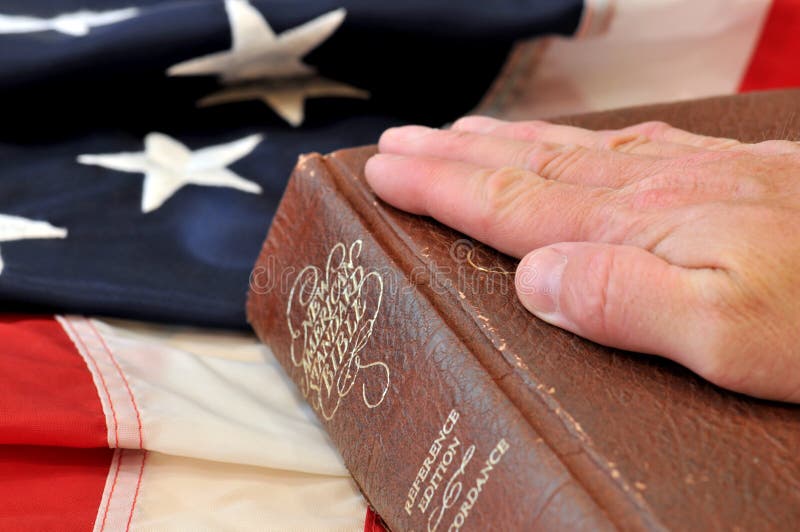 Hand on bible with flag background. Hand on bible with flag background.
