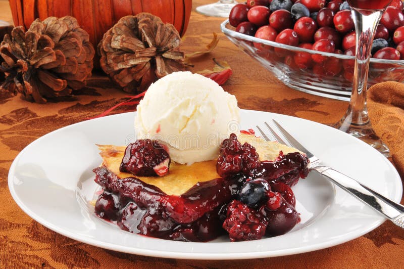 Fruit cobbler ala mode on a festive holiday table. Fruit cobbler ala mode on a festive holiday table