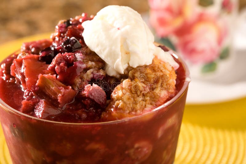 Berry and Peach Cobbler topped with a small scoop of vanilla ice cream. Berry and Peach Cobbler topped with a small scoop of vanilla ice cream.