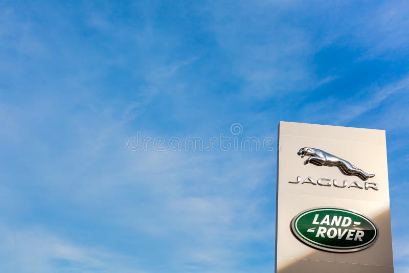 Jaguar Land Rover brand logo blue sky background