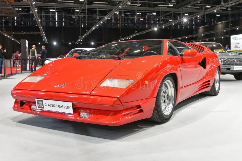 Named to honour the company's twenty-fifth anniversary in 1988, the 25th Anniversary Countach, although mechanically very similar to the 5000QV, sported considerable restyling done by Horacio Pagani. The Lamborghini Countach is a rear mid-engine, rear-wheel-drive sports car produced by the Italian automobile manufacturer Lamborghini from 1974 until 1990. It is one of the many exotic designs developed by Italian design house Bertone, which pioneered and popularized the sharply angled "Italian Wedge" shape. Named to honour the company's twenty-fifth anniversary in 1988, the 25th Anniversary Countach, although mechanically very similar to the 5000QV, sported considerable restyling done by Horacio Pagani. The Lamborghini Countach is a rear mid-engine, rear-wheel-drive sports car produced by the Italian automobile manufacturer Lamborghini from 1974 until 1990. It is one of the many exotic designs developed by Italian design house Bertone, which pioneered and popularized the sharply angled "Italian Wedge" shape.