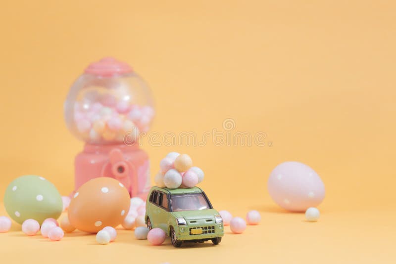 Easter eggs on vintage car with  Egg toy vending machine as background.Selective focus composition and soft pastel color toned for. Easter eggs on vintage car with  Egg toy vending machine as background.Selective focus composition and soft pastel color toned for