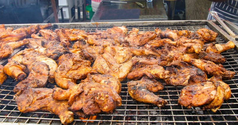 Jamaican jerk chicken on charcoal grill stock photo Jamaican jerk chicken on charcoal grill stock photo