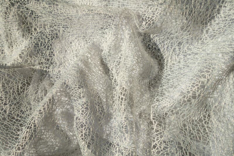 Jammed pure white web-like lacy fabric royalty free stock image