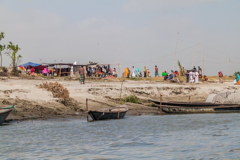 JAMUNA, BANGLADESH - NOVEMBER 7, 2016: Local people on a char sandbank island in Jamuna river near Bogra, Banglades