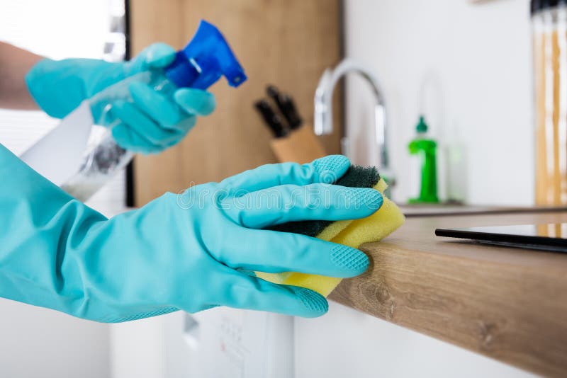 Janitor Cleaning Kitchen Worktop