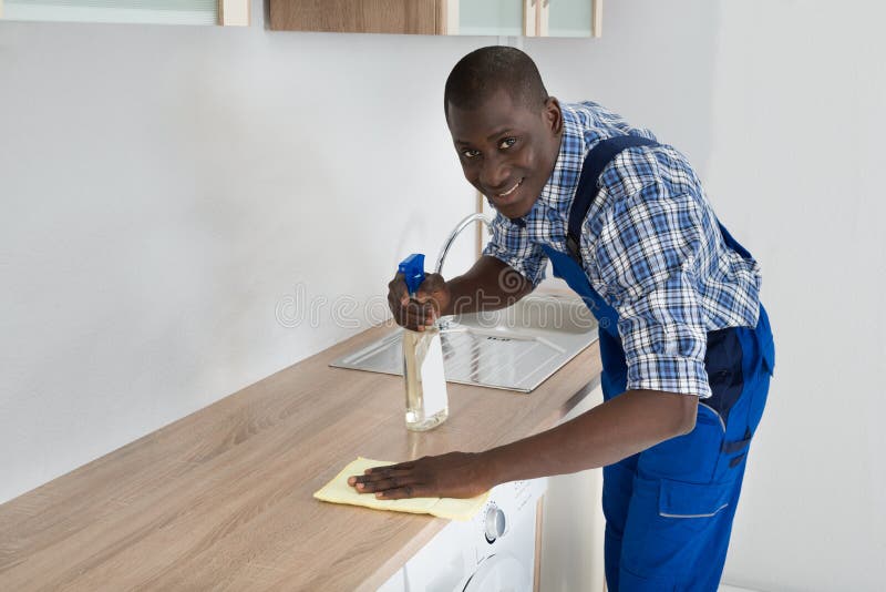 Janitor Cleaning Kitchen Worktop