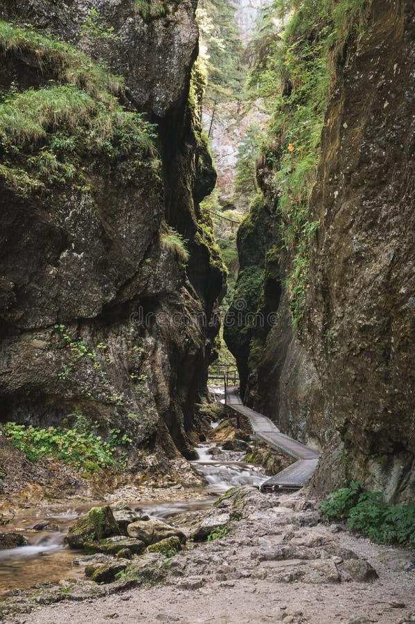 Janosikove diery - a famous tourist destination in Slovakia. A narrow rock alley. Plenty of waterfalls, benches, chains