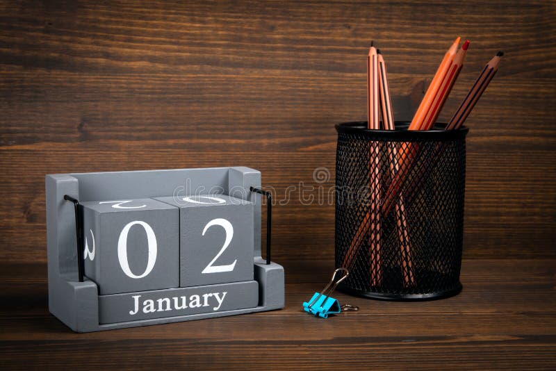 2 January inscription on wooden calendar. Wooden office desk. 2 January inscription on wooden calendar. Wooden office desk.