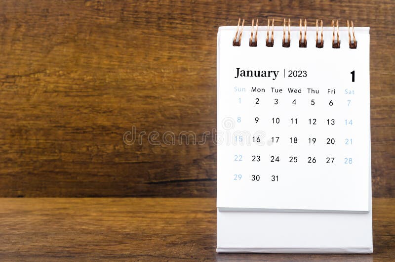 The January 2023 Monthly Desk Calendar for 2023 Year on Wooden Table