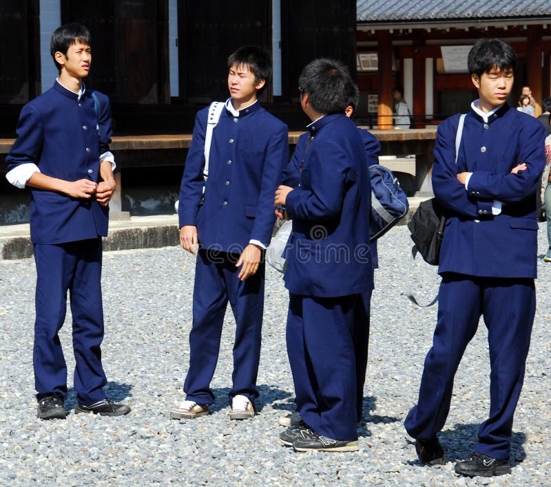 Premium Vector | Cute boy in a school uniform giving thumbs up