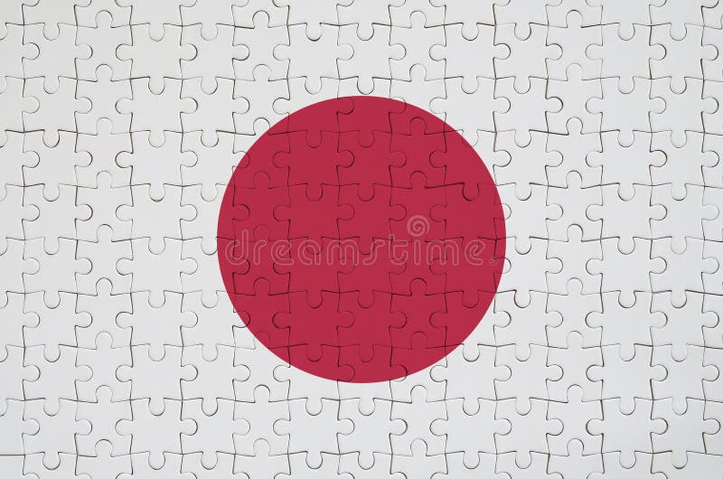 Japan-Flagge wird auf einem gefalteten Puzzlespiel dargestellt lizenzfreies stockbild Japan-Flagge wird auf einem gefalteten Puzzlespiel dargestellt lizenzfreies stockbild