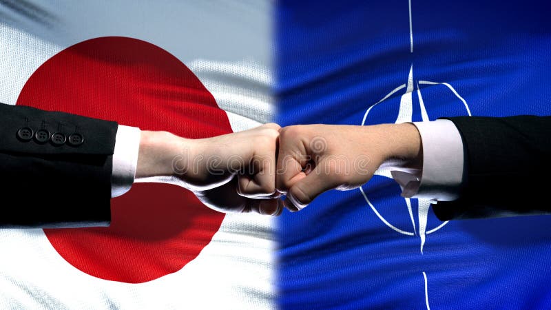 Japan vs NATO conflict, international relations crisis, fists on flag background royalty free stock photography Japan vs NATO conflict, international relations crisis, fists on flag background royalty free stock photography